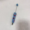 Detailed view of handmade blue rhinestone beaded pen with red heart motifs - Light Blue with AB Rhinestone Heart