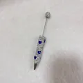 Macro detail view of handmade rhinestone pavé pen with elegant blue heart pattern accents - White with AB Rhinestone Heart