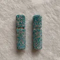 Detailed view of two 10ml portable perfume spray bottles encrusted with sparkling rhinestones - Mixed Lake Blue