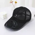Detail view of the solar-powered cooling fan on a breathable black mesh baseball cap. - Black
