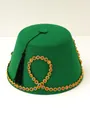 Detailed macro shot of green felt Turkish Fez hat with gold gemstone trim and tassel - Green