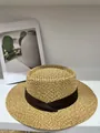 Detailed view of a hand-woven straw boater hat with a dark brown decorative ribbon. - M (56-58cm) / Khaki With Brown Ribbon