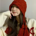 Stylish red hand-knitted beanie for women featuring decorative tassels and crochet patterns. - M (56-58cm) / Square Embossed Style / Red