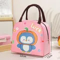 Detail view of pink insulated lunch bag featuring cartoon penguin and size markings - Penguin with Pumpkin Hat Pattern / Pink