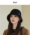 Close-up detail of a textured black wool bucket hat for women worn by a model for winter - M (56-58cm) / Black
