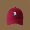 Detailed macro shot of a burgundy cotton baseball cap featuring a white embroidered letter R - Adjustable / Red (WH)