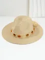 Detailed view of woven straw hat featuring amber bead trim and tassel accents. - M (56-58cm) / Beige