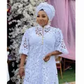 Detailed view of African white lace hollow maxi dress with elegant matching headwrap - One Size / Set / White