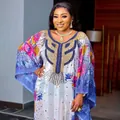 Detail of African chiffon dress with heavy gold beadwork and colorful floral patterns - One Size / Top And Bottom / Multicolor