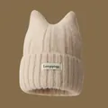 Beige knitted beanie with cute cat ears for autumn and winter warmth - Oatmeal with White Cloth Label