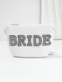 Detailed shot of white straw bride bag featuring sparkling rhinestone lettering. - Black Rhinestone Style