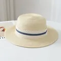 Close-up of French raffia straw hat with elegant lace and blue ribbon detail for summer. - One Size / Cream
