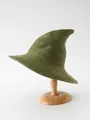 Olive green knitted wizard hat with a pointed top displayed on a wooden hat stand - Green