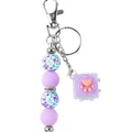 Purple silicone beaded keychain with floral patterns and pink cat paw fidget toy charm - Purple