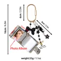 Detail view of mini keychain photo album with measurements and weight specifications - Black