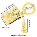 Floral print leather cardholder with yellow silicone bead wristlet and decorative tassel - Yellow