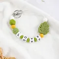 Handmade silicone monstera leaf beaded keychain with LOVE letter charms on white background - Olive