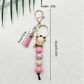Sleutelhanger met Highland cow, siliconen kralen, roze kwastje en gouden sluiting - Roze