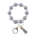 Iridescent purple and white silicone bead keychain bracelet with a grey tassel pendant - Gray