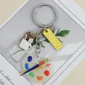 Creative painting theme keychain with palette, brush, pen cup, and ruler charms. - Yellow