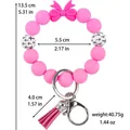 Roze siliconen kralen armband sleutelhanger met strik, kwastje en kruispatroon - Roze (Lichtgevend)