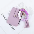 Purple silicone bead keychain with matching tassel and faux-leather card wallet. - Purple