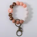 Floral silicone beaded wristlet keychain with peach and white beads - Coral