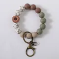 Stylish daisy silicone beaded keychain wristlet featuring earthy tones and bronze clasp - Tan