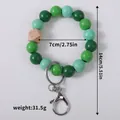 Handmade green wooden bead bracelet keychain with geometric wood bead and metal clasp - Green