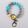 Colorful silicone bead keychain bracelet with a blue daisy charm and bronze clasp. - Lake Blue