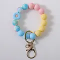 Colorful silicone beaded keychain bracelet featuring a blue daisy charm and gold clasp - Light Blue