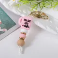 Handmade beaded keychain featuring a pink silicone coffee cup charm and natural wooden beads - Pink Cup