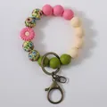 Colorful silicone bead wristlet keychain featuring pink daisy and floral print beads - Bright Pink