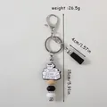 American style silicone keychain featuring a book stack charm and black tassel decor - Coffee Cup