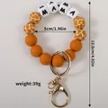 Orange silicone bracelet keychain with white MAMA beads and giraffe pattern beads - Chocolate