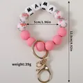 Pink silicone mama bead bracelet keychain with floral accents and exact dimensions - Peach