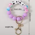 Porte-clés bracelet en perles de silicone violettes avec lettres MAMA et fermoir doré. - Violet