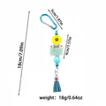 Detailed view of blue silicone bead keychain with sunflower tassel and dimension markings - Pendant Style / Mint Green Clasp