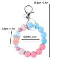 Cute blue and pink silicone beaded keychain bracelet with cartoon pencil charm and dimensions - Wristband Style / Pink