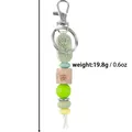 Elegant rose engraved silicone bead keychain with wooden butterfly detail for handbag - Green
