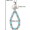 Blue silicone and natural wood beaded keychain wristlet featuring a bird charm 16cm length - Blue