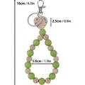 Handmade green silicone and natural wood beaded keychain wristlet with leaf charm detail - Green