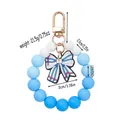 Blue and white silicone beaded keychain wristlet bracelet with a striped bow charm - Blue