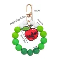 Silicone beaded keychain bracelet with apple teacher charm and weight measurement info. - Green