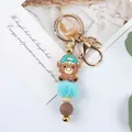 Cute cartoon cow keychain with blue pom-pom and silicone beads bag charm. - Hat Style / Green