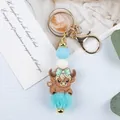 Cartoon highland cow silicone bead keychain with turquoise pom-pom and gold lobster clasp - Bowknot Style / Mint Green