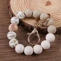 Silicone beaded wristlet keychain with leaf prints and natural wooden bead detail - Sand