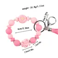 Pink silicone daisy beaded wristlet keychain with tassel and specific size markings - Pink