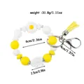 Daisy silicone beaded keychain bracelet in yellow and white with tassel and leaf charm - Yellow