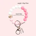 Pink and white silicone beaded keychain with natural wooden bead and rose gold clasp - Pink